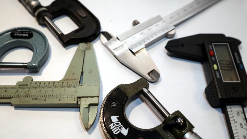 Calibrated micrometers and calipers used for precision dimensional inspection